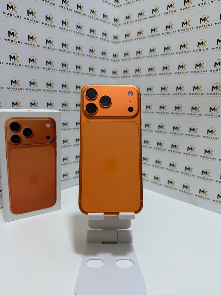 Two orange iPhone cases displayed on a white stand against a branded backdrop with repeating MK logos