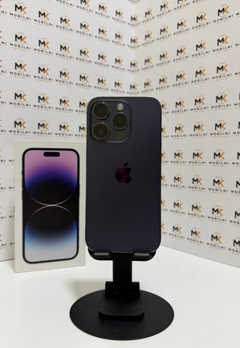 Black iPhone 14 Pro displayed on a stand next to its packaging box against a branded backdrop
